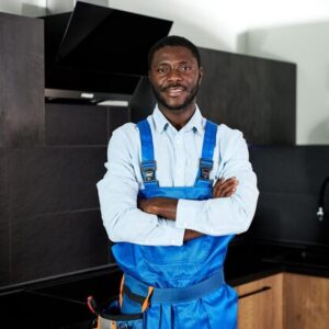smiling-handsome-young-african-handyman-plumber-blue-uniform-young-skilled-handyman-overall-st_183219-9115